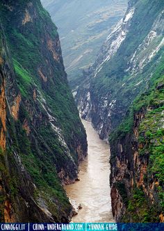 a river flowing through a canyon surrounded by mountains