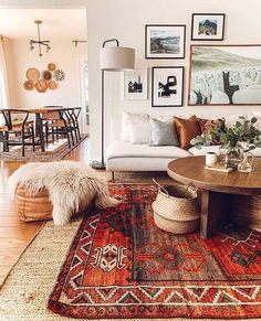 a living room filled with lots of furniture and pictures on the wall above it's coffee table