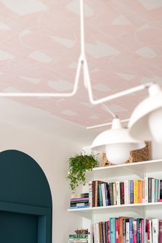 a room with bookshelves and shelves filled with various types of books on them