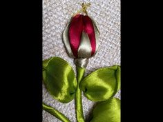 a red and green flower on a white cloth