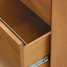 an open drawer is shown with metal handles and drawers on both sides, which are made of wood