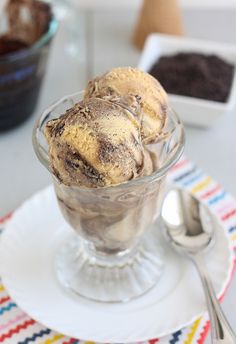 three scoops of ice cream in a glass bowl