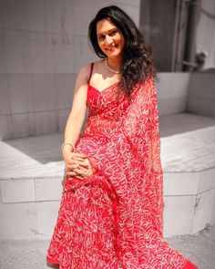 a woman in a red dress posing for the camera