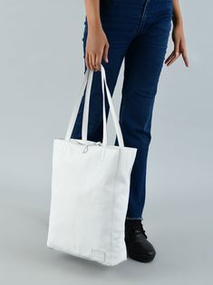 Step out in style and confidence with this iconic white leather shoulder tote bag, a classic embodiment of grace and functionality. Handcrafted by skilled artisans, it radiates timeless craftsmanship. Crafted from full-grain buffalo soft leather, it blends durability with an enduring charm. The secure zipper closure safeguards your essentials, while a thoughtfully designed inside pocket organizes coins, keys, purse, or your phone. Ideal for office use, it accommodates tablets or small laptops wi White Shoulder Bag With Leather Handles For On-the-go, Luxury White Shoulder Bag With Smooth Grain, White Soft Leather Bags, White Rectangular Shoulder Bag With Smooth Grain, White Soft Leather Shoulder Bag With Double Handle, Modern White Leather Bag, White Smooth Grain Bag For Shopping, White Smooth Grain Shopping Bag, White Leather Shoulder Bag For Everyday Use