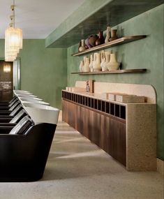 a row of black and white vases sitting on top of a counter in a room