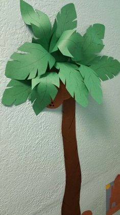 a paper cut out of a tree with leaves on it's head and bottom part