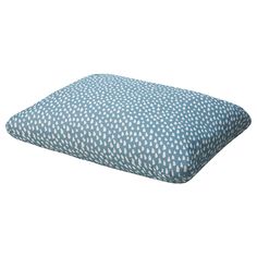 a blue and white polka dot pillow on a white background