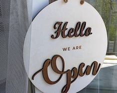 there is a sign that says hello we are open