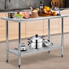 a stainless steel table with pots and pans on it