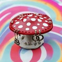 a small red and white mushroom sitting on top of a table with rings around it