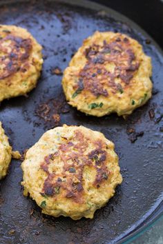 four crab cakes cooking in a skillet