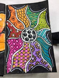 an art journal with colorful designs on it