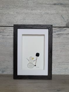 a black and white frame with a picture of a snowman holding a hockey stick