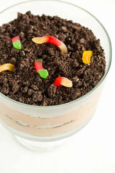 a bowl filled with dirt and candy worms