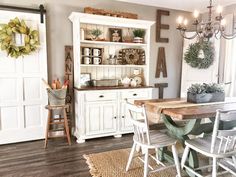 a dining room table with chairs and a hutch in the back ground next to it