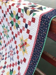 a close up of a quilt on a bench