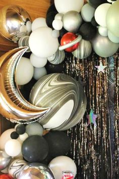 an assortment of balloons and streamers on a table