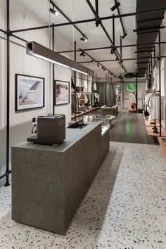 the inside of a clothing store with clothes on display