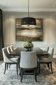 a dining room table with white chairs and a black chandelier hanging over it