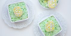 three white plates topped with cake covered in green frosting and sprinkles