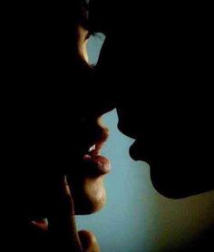 the silhouette of two people kissing each other