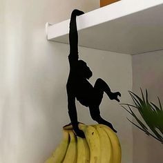 a monkey figurine sitting on top of some bananas