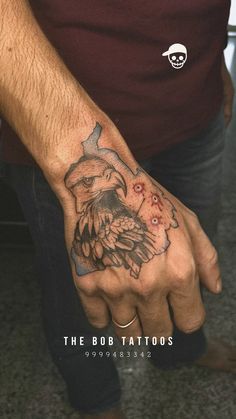 a man with a tattoo on his hand and an eagle in the middle of it