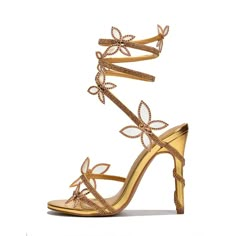 Step into the spotlight with our Gold Open Toe Party Shoes. These stunning sandals feature a rhinestone butterfly design and wrapped heels, perfect for adding glamour to any special occasion. Color: Gold Heel Type: Stiletto heel Heel height: 4.5" / 115 mm approx Product measurements were taken using size 8. Please note that measurements may vary by size. Toe: Open toe Wrapped style Rhinestone and butterfly embellishment Handcrafted US sizing. Fits true to size. Gold Heels Wedding, Hoco Heels, Wrap Around Heels, Pencil Heels, Golden Shoes, Butterfly Shoes, Formal Heels, Cowboy Shoes, Dance Heels