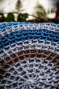 a crocheted blanket is sitting on a table