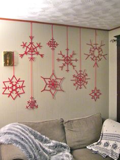 a living room filled with furniture covered in snowflakes hanging from the ceiling above