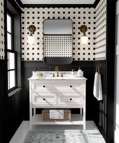 a bathroom with black and white wallpaper, two sinks and a mirror on the wall