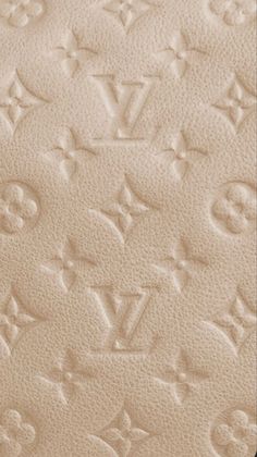 an up close view of the texture of a louis vuitton leather bag with monograms on it