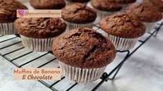 muffins de banana & chocolate on a cooling rack with the words,'muffins de banana & chocolate '