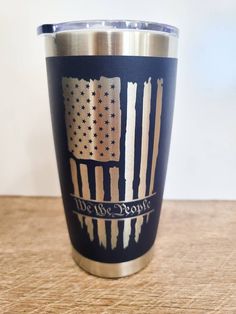 a stainless steel tumbler with an american flag on it