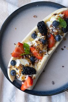 a plate that has some kind of food on it with berries and yogurt