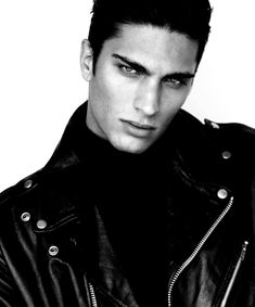 a young man wearing a black leather jacket