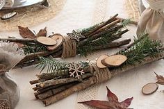 some branches are wrapped in twine and sitting on a table next to other items