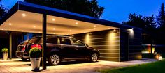 two cars are parked in front of a house at night with lights on the roof