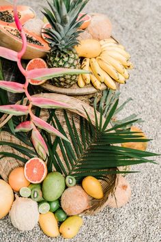 there are many different types of fruits in the basket on the floor next to each other