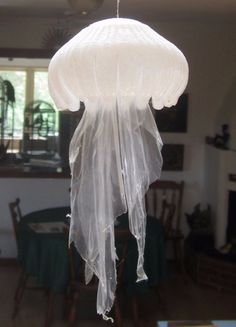 a white light hanging from a ceiling in a living room