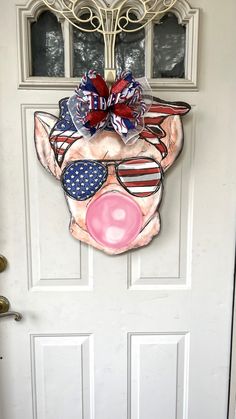 a door decorated with a pig mask and american flag shades on it's face