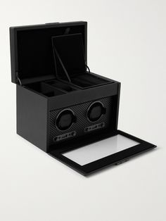 When silversmith Mr Philipp Wolf noticed customers were more interested in his fine leather cases than his silver, he decided to give packaging more attention, the rest, as they say, is history. With five generations and over 185 years of design, this 'Axis' watch winder, with its patented technology and custom powder-coated plating, is a pinnacle of the brand's innovation. It's handcrafted from vegan leather and engineered to wind your timepieces with an LCD control panel on the front, so you c Luxury Black Watch Accessories As Gift, Luxury Black Watch Accessories With Polished Finish, Luxury Black Watch Accessories For Gift, Black Rectangular Watch Accessory With Polished Finish, Black Polished Rectangular Watch Accessory, Elegant Black Watch Accessories With Box, Wolf Gifts For Men, Modern Black Watch Accessories With Box, Luxury Leather Automatic Watch Accessories