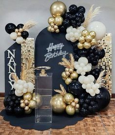 a black and gold birthday party with balloons