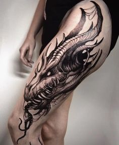 a woman's leg with a dragon tattoo design on it, and her legs