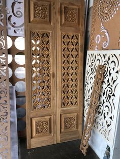 an intricately carved wooden door is shown in front of some decorative wallpapers