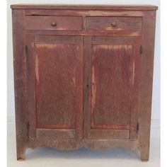 an old wooden cabinet with two doors on the front and one door open to reveal something