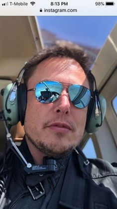 a man wearing sunglasses and headphones sitting in a car