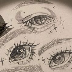 some very pretty eyes with long lashes and stars on it's forehead, as well as an eyeliner pencil drawing