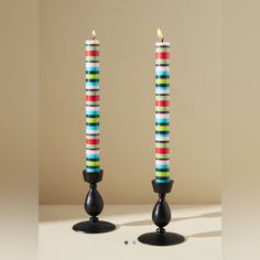 two colorful candles sitting next to each other