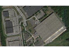 an aerial view of a parking lot with lots of cars parked in front of it